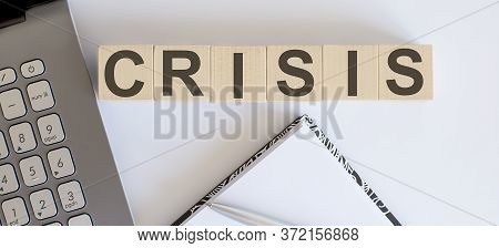 Business Concept Text On Wood Block Crisis With Laptor And Notebook