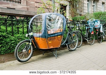 Paris, France - Mar 16, 2014: New Babboe City Parked On Empty Street An Agile And Flexible Cargo Bik