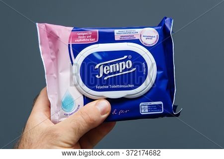Paris, France - Aug 7, 2019: Pov Male Hands Holding Fresh Toilet Wet Paper Manufactured By Tempo Feu