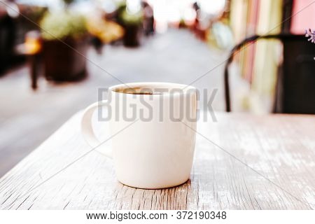 Cup Of Coffee In The Street Or Outdoors At Coffee Shop Or Cafe With Blurred Background