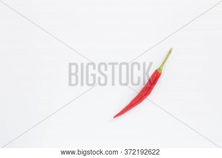 A Lot Of Red Hot Chili Peppers On A White Background. A Concept Hot Spice For Food. Top View, Flat L