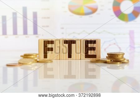 Full Time Equivalent. Fte The Word On Wooden Cubes, Cubes Stand On A Reflective Surface, In The Back