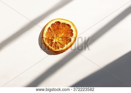Dried Orange Slice In Intence Sunlight, Sunburn Warning, Dry Skin, Drying Danger