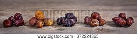Dried Dates On Wooden Table, Variety Mix Of Sorts, Medjool, Mazafati, Sukkary, Bawalini And Khidri, 