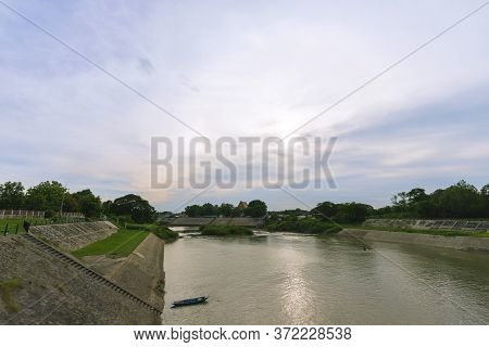 View Of The Pasak River Behind The Rama Vi Dam In The Evening.