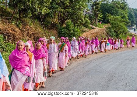 Hsipaw, Myanmar - December 1, 2016: Young Buddhist Nuns Go For Morning Alms In A Village Near Hsipaw