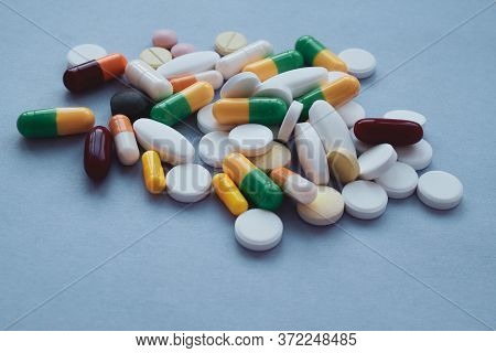 Colorful Pills And Capsules On A Blue Background, Macroshot Tablets