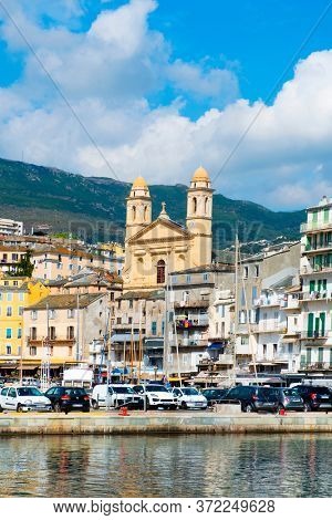 BASTIA, FRANCE - SEPTEMBER 16, 2018: A view of the Vieux Port, the Old Port of Bastia, in Corsica, France, highlighting the Saint-Jean-Baptiste Church with its characteristic twin bell towers