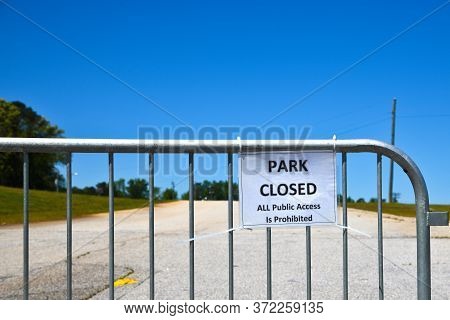 Baricade And Park Closed To All Public Access Sign During Pandemic Shutdown