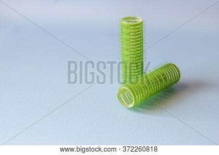 Hair Culers On The Blue Backround. Green Culers For Hairdress. Top View.