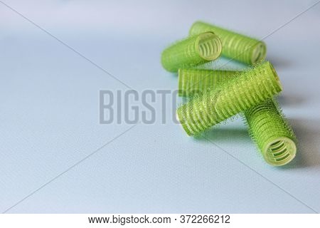Hair Culers On The Blue Backround. Green Culers For Hairdress. Top View.