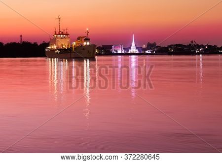 Chao Phraya River In The Evening, When The Sun Sets, There Are Large Boats Docking Among The Calm Ri