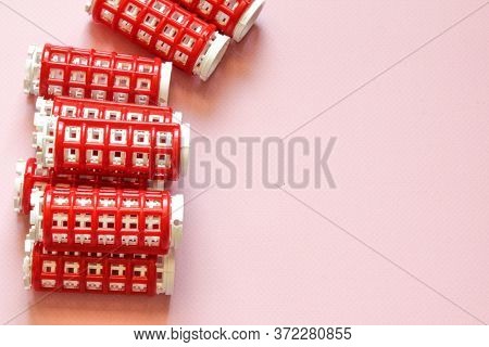 Hair Culers On The Pink Backround. Red Culers For Hairdress. Flat Lay