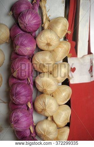 Colorful Bundles Of Onions Hang Close Up