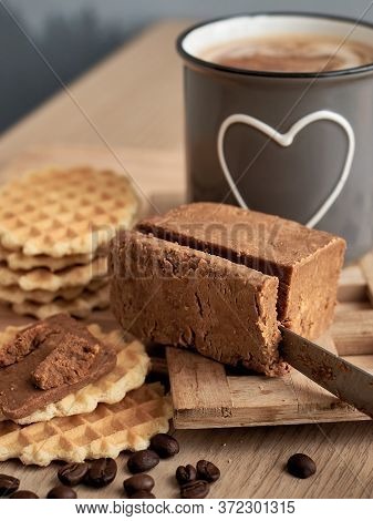 Norwegian Brunost Cheese With Viennese Waffles And A Cup Of Coffee In The Background. Breakfast With