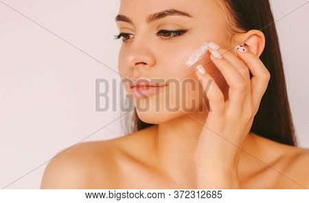 Portrait Young Sensual Beautiful Woman With Perfect Smooth Skin Apply Moisturizing Lotion On Face Is