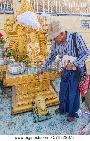 Yangon, Myanmar - December 15, 2016: Local Man Performing A Ritual At Botataung Paya Pagoda In Yango