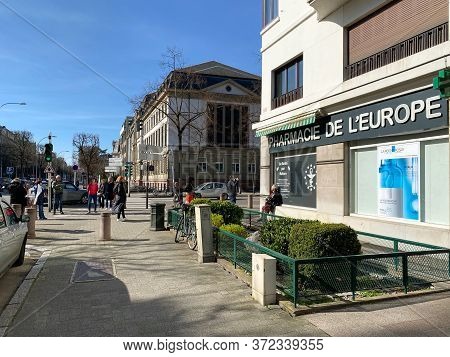 Strasbourg, France - March 16, 2020: Wide Angle View Of Multiple People Waiting In Queue To Enter Th