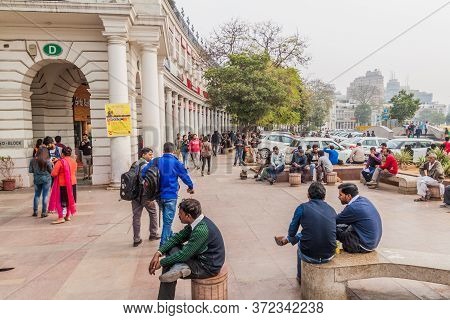 Delhi, India - January 24, 2017: People Walk On A Sidewalk At Connaught Place In Delhi.