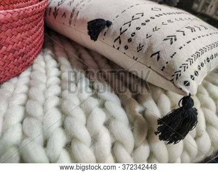 A White Pillow On A Wool Sofa