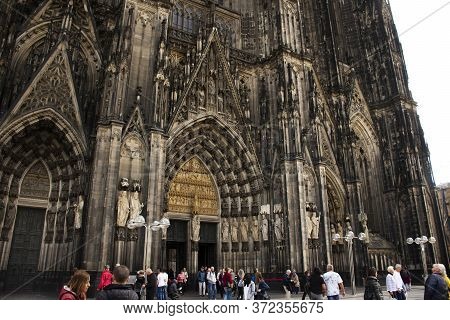 German People And Foreign Travelers Travel Visit And Respect Praying God At Cologne Cathedral Or Hoh