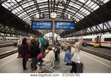 German People And Foreign Travelers Walking Waiting Train In Terminal At Koln Or Kolne Central Haupt