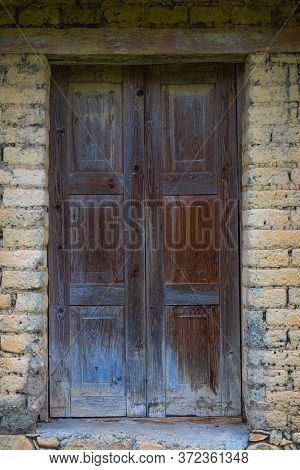 A Humble Home, Made Of Adobe Bricks, With An Old Wooden Door In The Small Town Of El Chorrito, Tamau