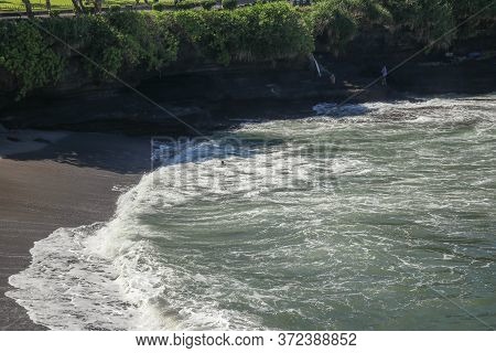 Extreme Sports Surfing On Waves In The Ocean. Surfer Fell From The Board And Tried To Catch His Boar