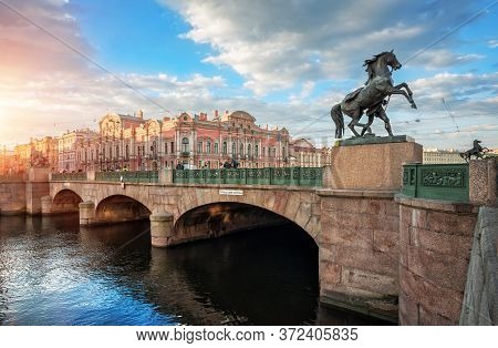 Anichkov Bridge In St. Petersburg With Sculptures Of Horses And A Sunny Summer Morning.  Inscription