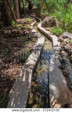 Traditional Irrigation Canal Called Falaj In Wadi Tiwi Valley, Oman