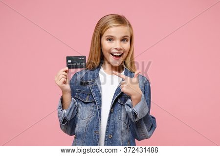 Funny Little Blonde Kid Girl 12-13 Years Old In Denim Jacket Posing Isolated On Pastel Pink Wall Bac