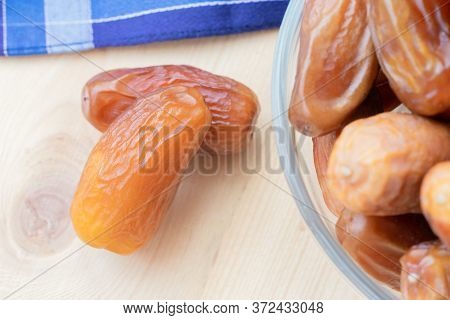 A Few Of Dried Sweet Deglet Nour Date Fruites On Wooden Table.organic Vegetarian Food