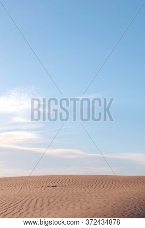 Sand Dunes And Ripples In The Desert On A Clear, Sunny Day. Plenty Of Negative Space.