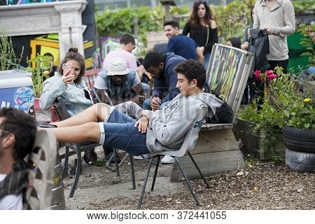 London, Uk - 17 July 2019, Nomadic Community Garden. Communal Garden Party. A Girl Takes Pictures Of