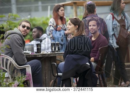 London, Uk - 17 July 2019, Nomadic Community Garden. Communal Garden Party. Two Men Are Sitting On M