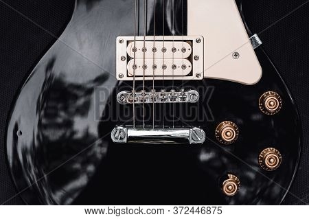 Black And White Electric Bass Guitar. Musical Instrument Close-up. Stylish Still Life With Parts Of 
