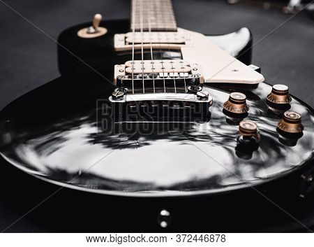 Black And White Electric Bass Guitar. Musical Instrument Close-up. Stylish Still Life With Parts Of 