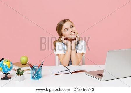 Pensive Little Kid Schoolgirl 12-13 Years Old Study At White Desk With Pc Laptop Isolated On Pink Ba