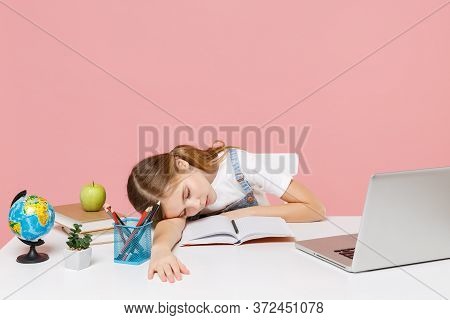 Tired Little Kid Schoolgirl 12-13 Years Old Sit Study At Desk With Pc Laptop Isolated On Pink Backgr