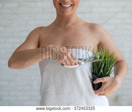 Unrecognizable Woman Shears A Potted Plant With Scissors. Axillary Depilation. Smiling Girl Removes 
