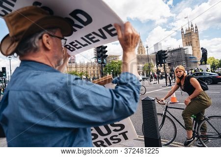 London / Uk - 06/20/2020: Street Preacher Outside The British Parliament Stating Jeus Christ Will Re