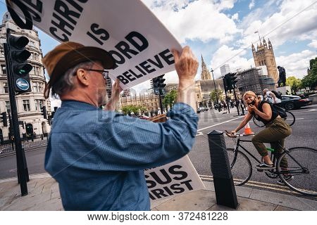 London / Uk - 06/20/2020: Street Preacher Outside The British Parliament Stating Jeus Christ Will Re