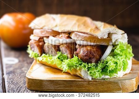 Brazilian Beef Sandwich, Sausage, Tomato, Lettuce And Onion In A Salt Bread.