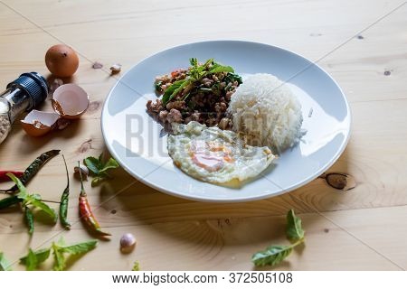 Rice Topped Of Food Rice Topped With Stir-fried Pork And Basil On Wood Background.  Thai  Street Foo