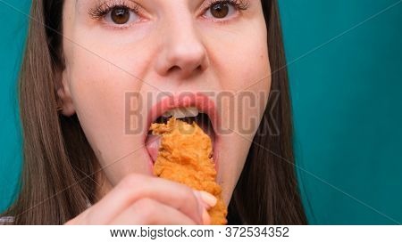 Young Happy Woman Eating Deep Fried Chicken, Closeup. Woman Eats Chicken Wings, Calorie Intake And H