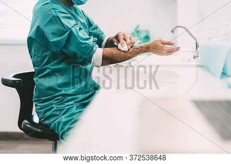 Surgeon Washing Hands Before Operating Patient In Hospital - Medical Worker Getting Ready For Fighti