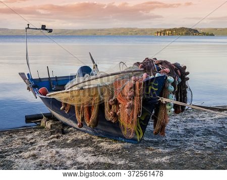 Traditional Fishermen Boat Docked On Marta Beach, A Little Medieval Village On Bolsena Lakeshore, Vi