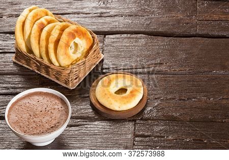 Pandequeso Traditional Colombian Food - Hot Drink Chocolate. Wood Background
