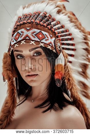 Close-up Portrait Of A Nude Female Wearing Feather Mayan Headdress, Aztec Conceptual Look