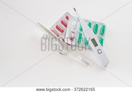Mercury And Digital Thermometers And Color Pills